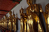 Bangkok Wat Pho, Buddha gilded statues lined in the double cloister enclosing the ubosot.  